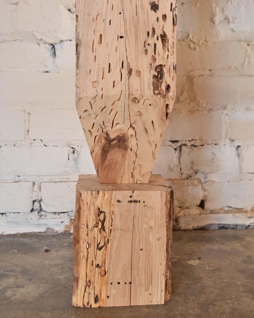 sculpted edges on wooden pedestal