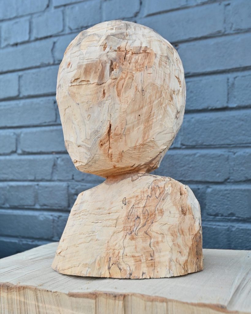 hatchet carved wooden bust done in artistic style