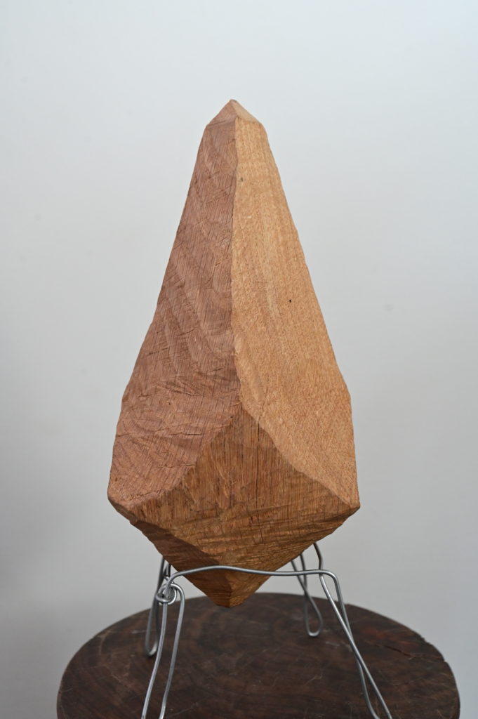 a wooden sculpture on display at an art museum