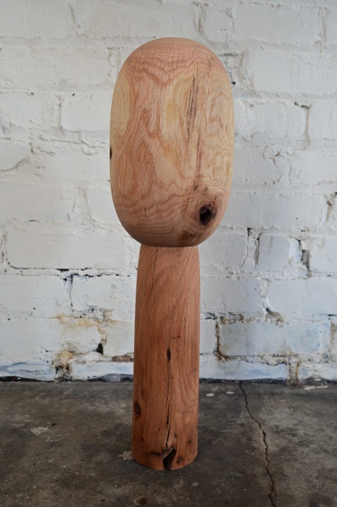 a wooden sculpture of a primitive totem