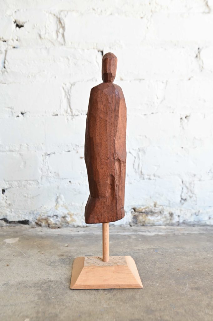 a carved wooden figure of aperson